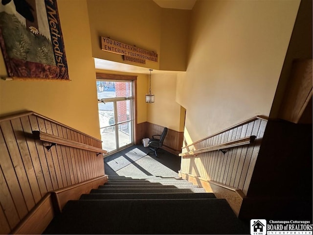 stairway featuring carpet floors