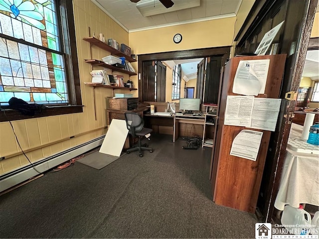 office area featuring ceiling fan, ornamental molding, wood walls, and a baseboard heating unit