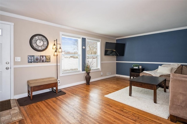 sitting room featuring wood-type flooring and ornamental molding