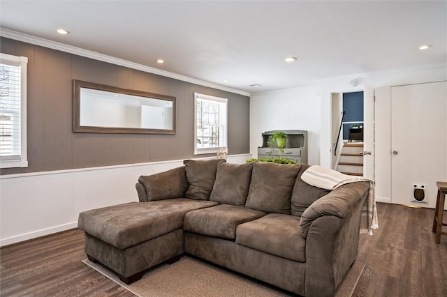 living room with crown molding, plenty of natural light, and dark hardwood / wood-style flooring