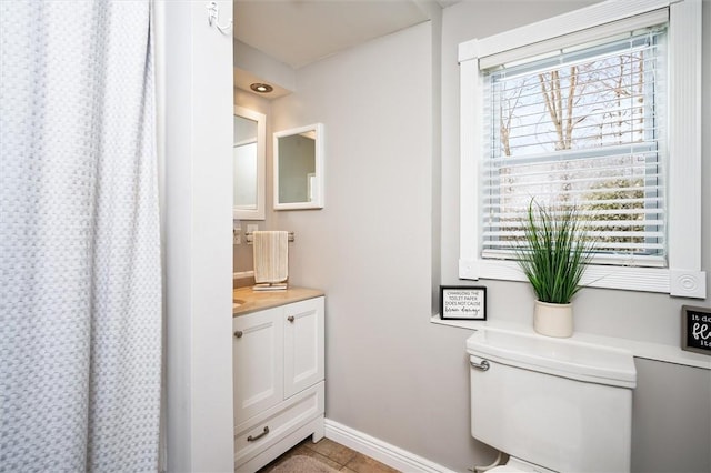 bathroom featuring vanity, tile patterned floors, and toilet