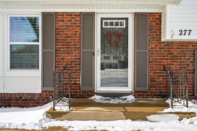 view of snow covered property entrance