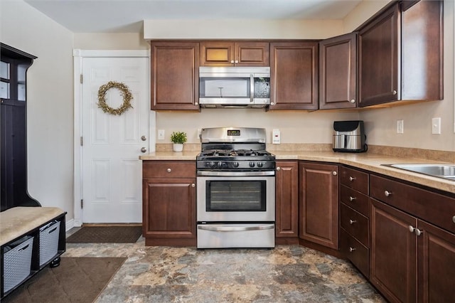 kitchen featuring stainless steel appliances and dark brown cabinets