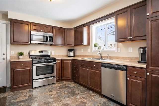 kitchen featuring stainless steel appliances, sink, and dark brown cabinets