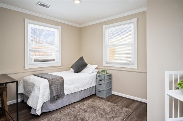 bedroom with crown molding and dark hardwood / wood-style flooring