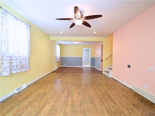 empty room with ceiling fan and light wood-type flooring