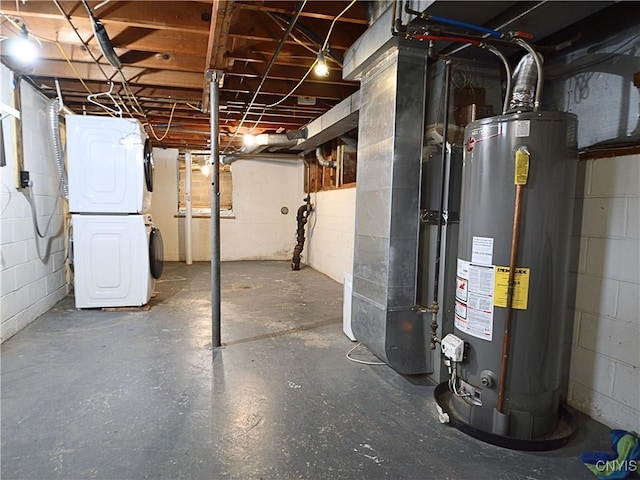 basement with stacked washing maching and dryer and water heater