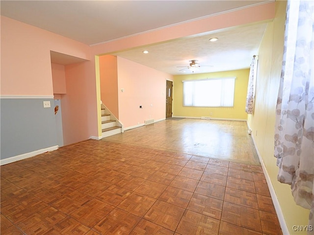 spare room featuring parquet floors and ceiling fan