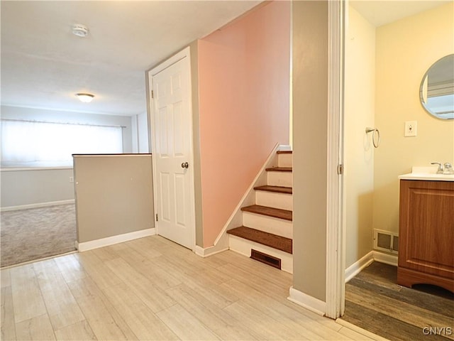 stairway featuring hardwood / wood-style flooring