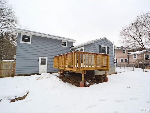 snow covered property with a deck