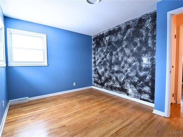 empty room featuring hardwood / wood-style flooring