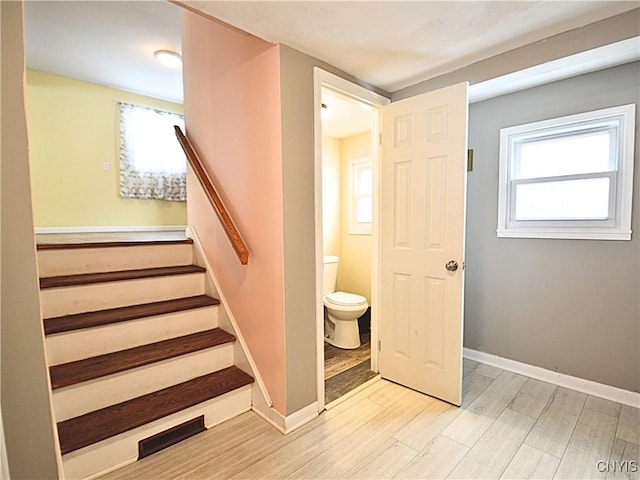 stairway featuring wood-type flooring