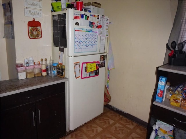 kitchen with white refrigerator and light parquet floors