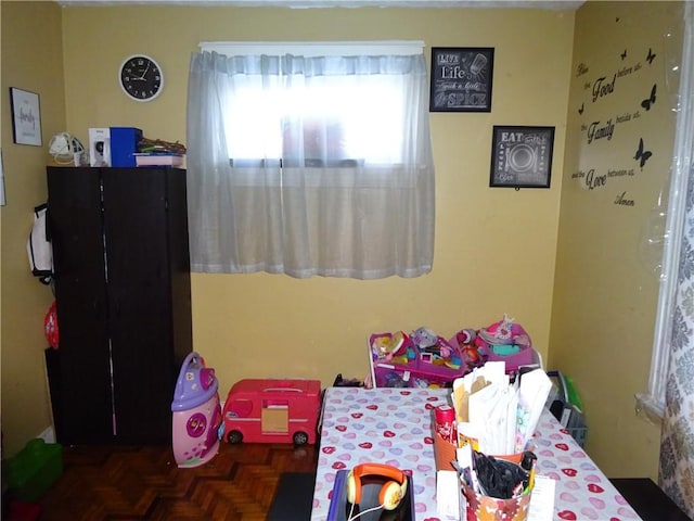 bedroom with dark parquet flooring