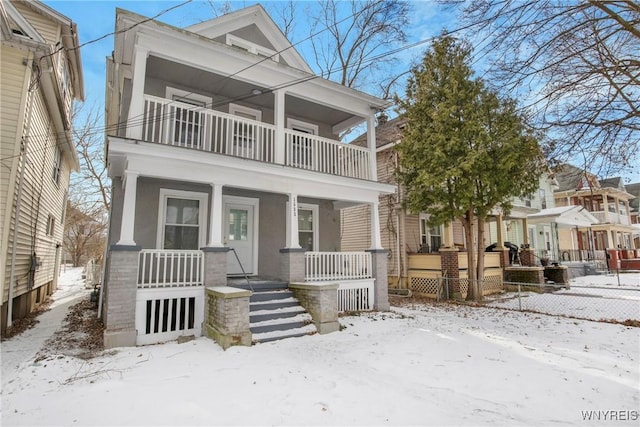 view of front of property with a balcony and covered porch