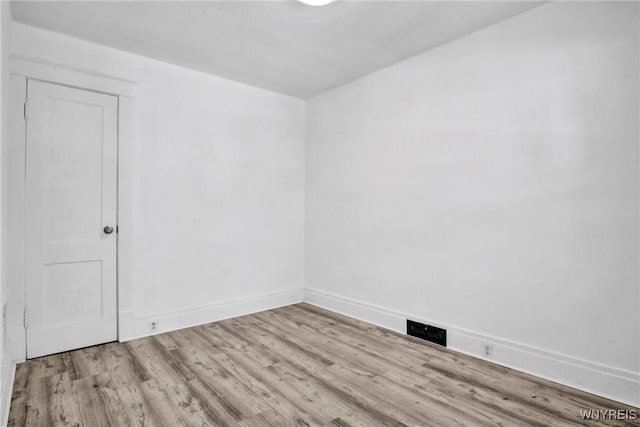 spare room with light wood-type flooring