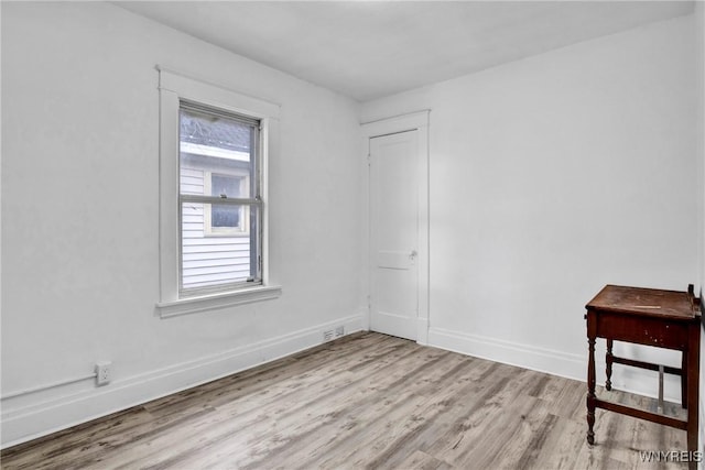 spare room with light hardwood / wood-style flooring