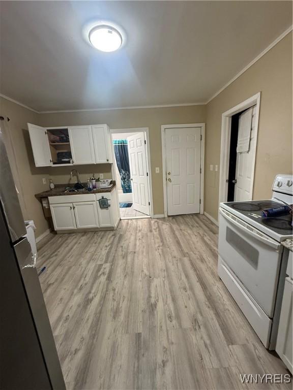 kitchen featuring crown molding, white cabinets, light wood-type flooring, and white range with electric cooktop