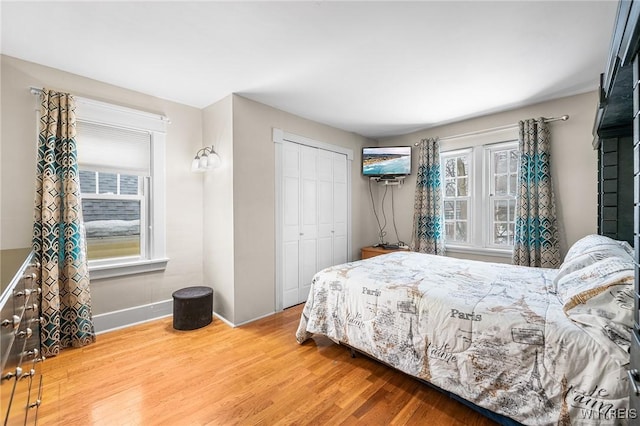 bedroom with hardwood / wood-style flooring and a closet