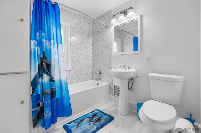 full bathroom featuring toilet, sink, and shower / bath combo with shower curtain