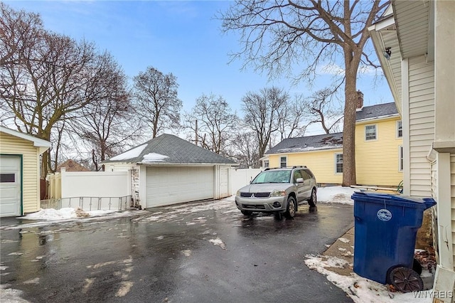 view of property exterior with a garage and an outbuilding