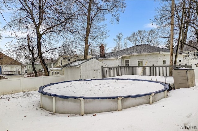 view of snow covered back of property