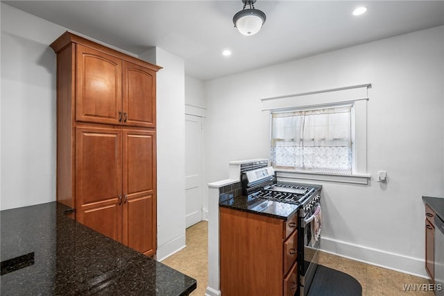 kitchen featuring stainless steel appliances and dark stone countertops