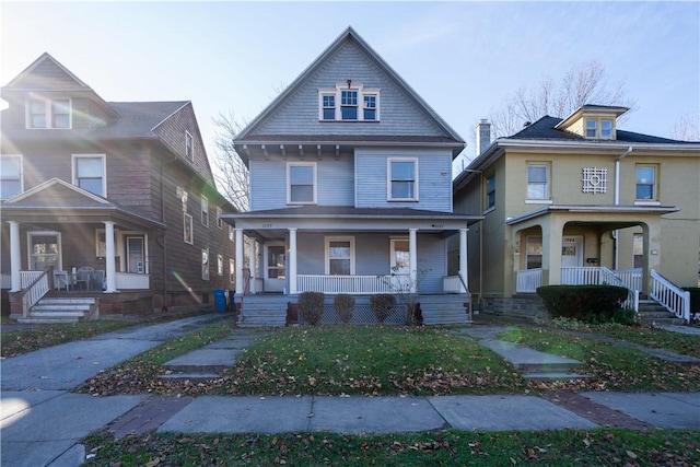 view of front facade with a front yard and covered porch