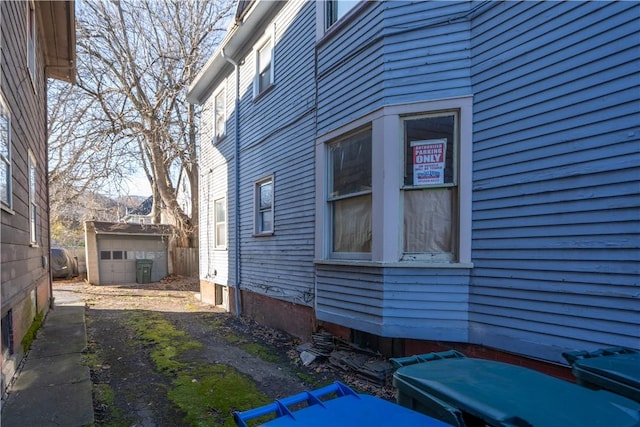 view of side of property featuring a shed