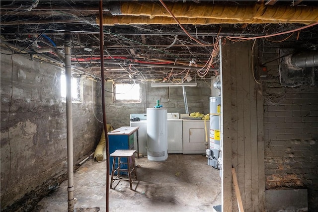 basement featuring washing machine and clothes dryer and water heater