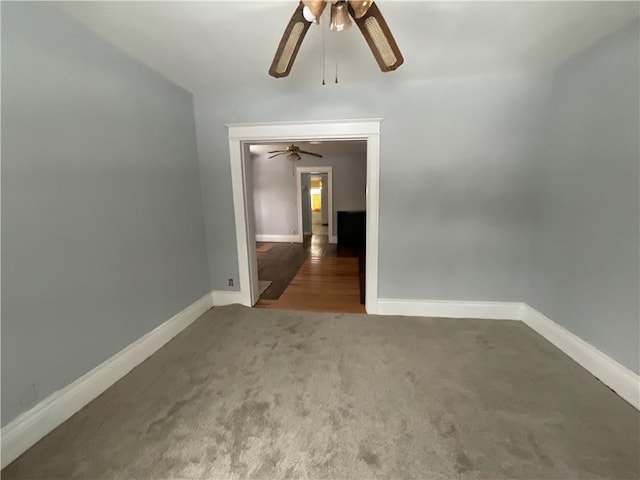 unfurnished room with ceiling fan and carpet