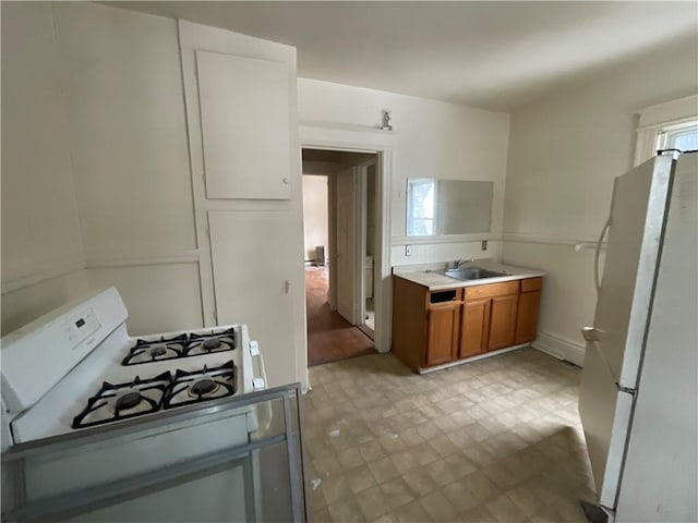 kitchen featuring sink and white appliances