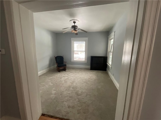 unfurnished room with ceiling fan and carpet