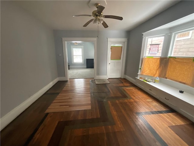 unfurnished room featuring dark hardwood / wood-style flooring and ceiling fan