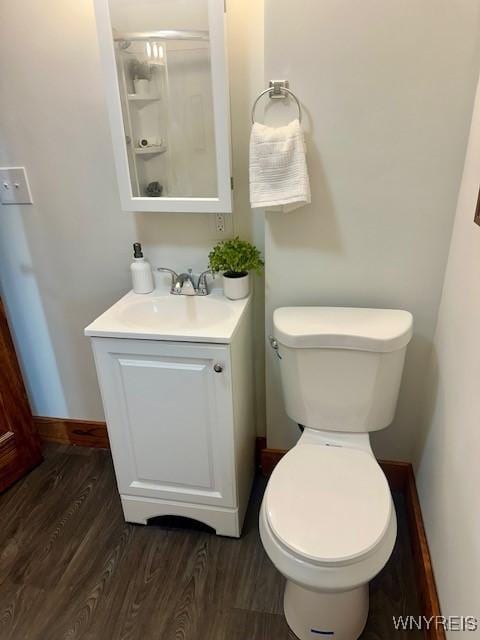 bathroom featuring hardwood / wood-style flooring, vanity, and toilet