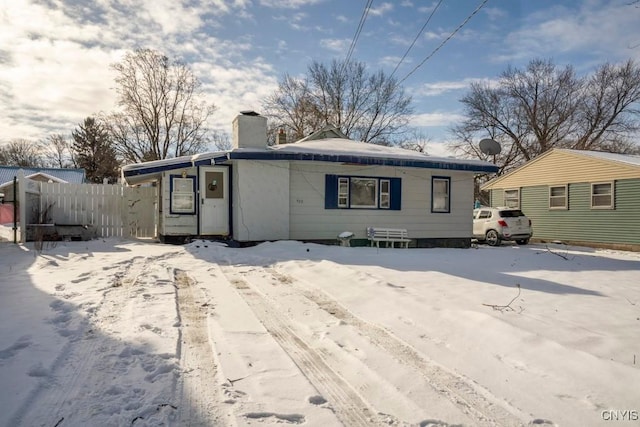 view of snow covered back of property