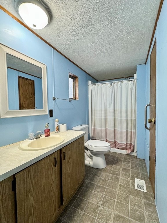 bathroom featuring vanity, toilet, and a textured ceiling