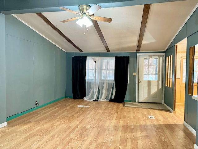 empty room featuring ceiling fan, vaulted ceiling with beams, and light hardwood / wood-style floors