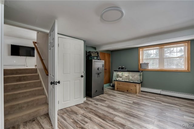 interior space featuring a baseboard radiator and light hardwood / wood-style floors