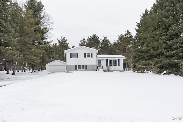 view of front of home with a garage and an outdoor structure