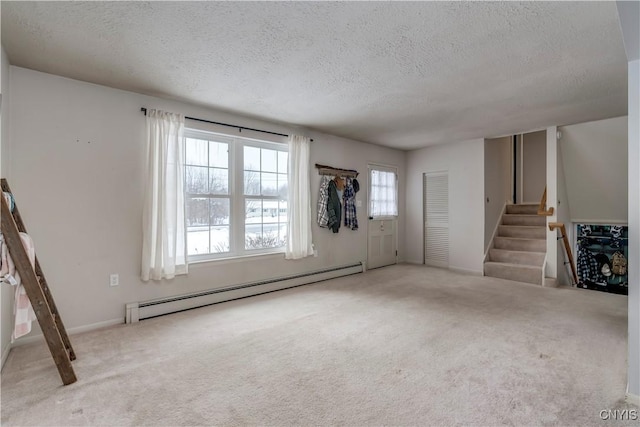 unfurnished living room featuring light carpet, a textured ceiling, and baseboard heating