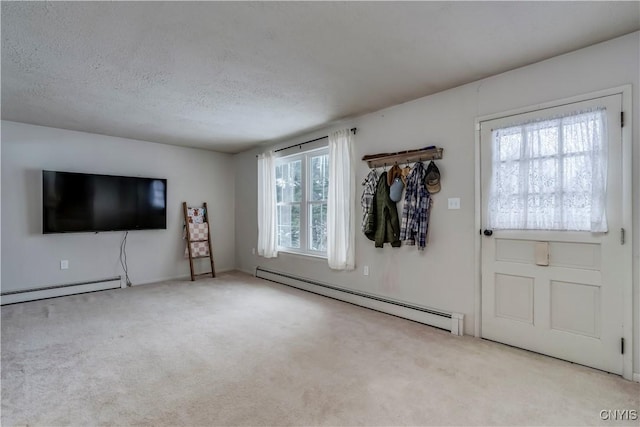 interior space with a baseboard radiator and a textured ceiling