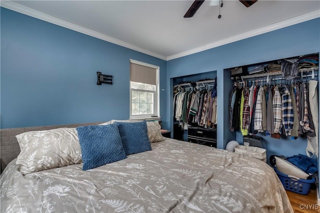 bedroom with multiple closets, ornamental molding, and ceiling fan