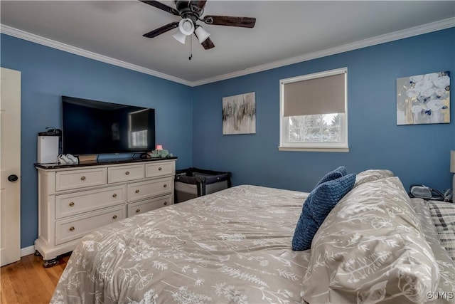 bedroom featuring light hardwood / wood-style flooring, ornamental molding, and ceiling fan