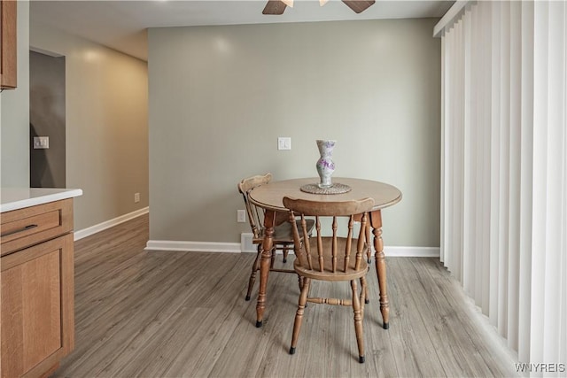 dining room featuring light hardwood / wood-style flooring and ceiling fan