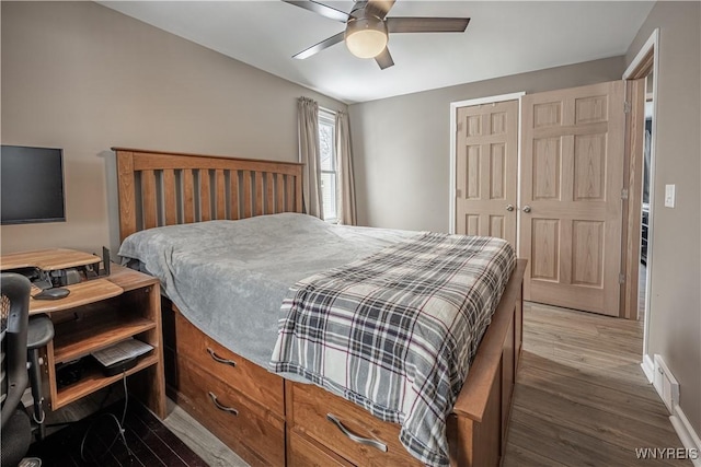 bedroom with hardwood / wood-style floors, ceiling fan, and a closet