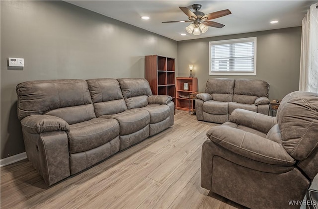 living room with light hardwood / wood-style floors and ceiling fan