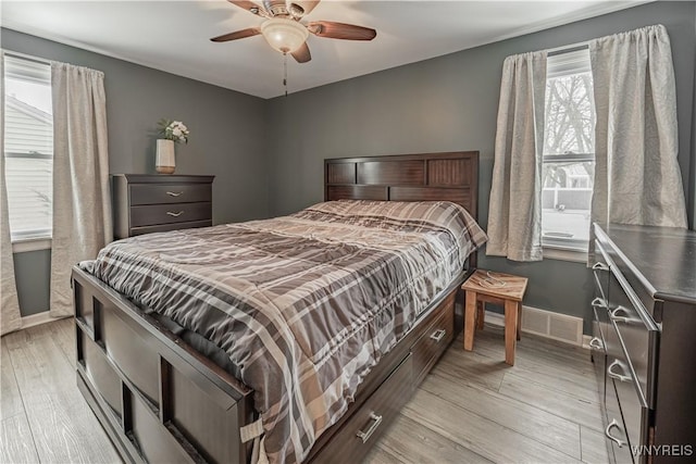 bedroom featuring light hardwood / wood-style floors and ceiling fan