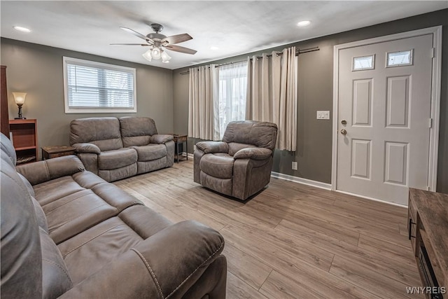 living room with ceiling fan and light hardwood / wood-style floors