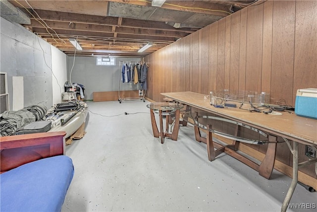 basement featuring a workshop area and wood walls